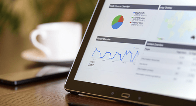 A tablet screen displaying traffic analytics with graphs and charts, representing SEO insights and data analysis for website optimization.